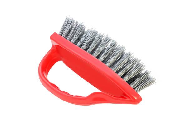 Red kitchen plastic brush in the shape of an iron isolated on a white background