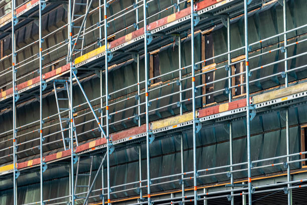 istock perspective view of building under construction with metal scaffolds, construction site of repair building. 1227420487