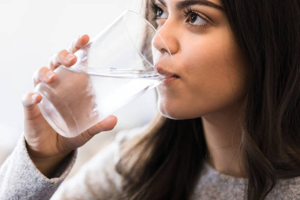 istock Healthy young woman drinking water 1227422614