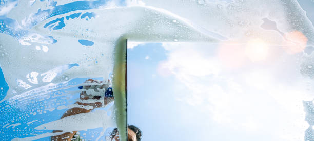 istock window cleaner cleaning window with squeegee and wiper on a sunny day 1227422645