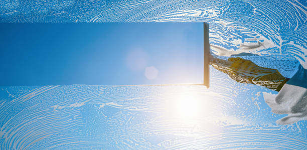 istock window cleaner cleaning window with squeegee and wiper on a sunny day 1227422647