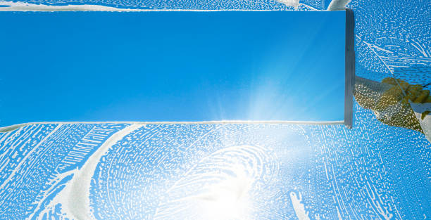 istock window cleaner cleaning window with squeegee and wiper on a sunny day 1227422652