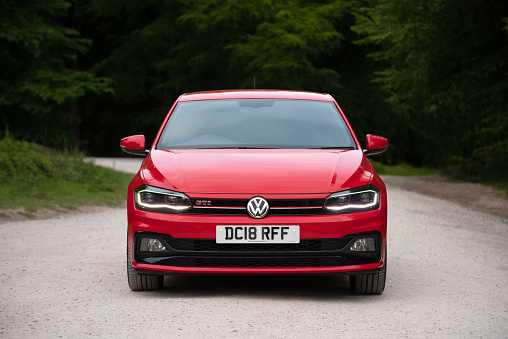 Staffordshire, England, UK - 26th May 2020:  A MK6 Volkswagen Polo GTI Plus in Flash Red, parked on gravel road in Cannock Chase, Staffordshire, England, UK. The VW Polo is now in it's sixth generation.