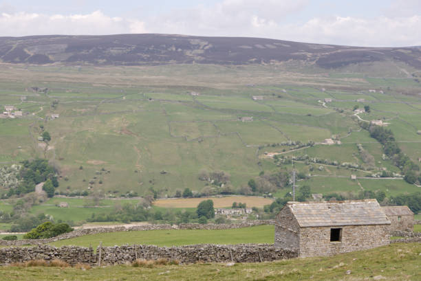 istock Dry stacked stone wall and stone building 1227425210