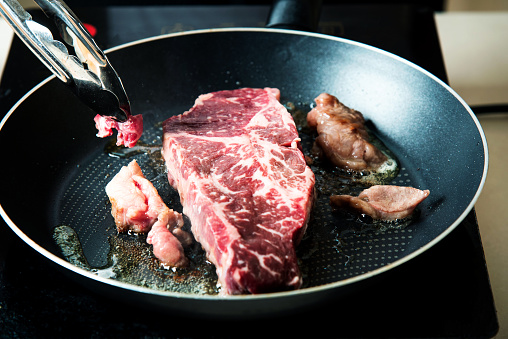 Wagyu Japanese beef steak frying on the pan closeup. Home food preparation