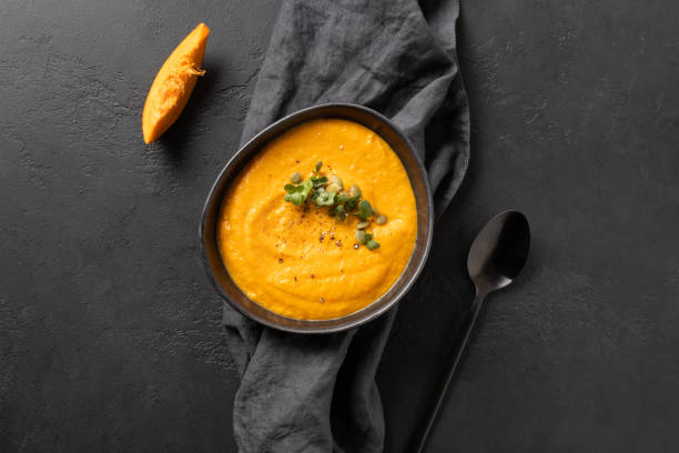 istock Fall pumpkin soup with crackers on grey background. Top view. Space for text. 1227425340