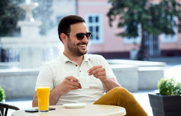 istock Young man sitting in the cafe and drinking coffee. Lifestyle concept 1227427556