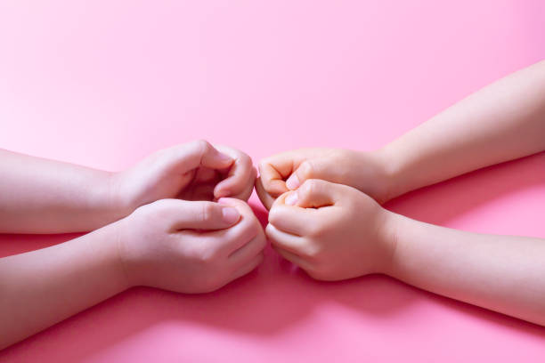 istock Two hands of young children making a heart 1227428251