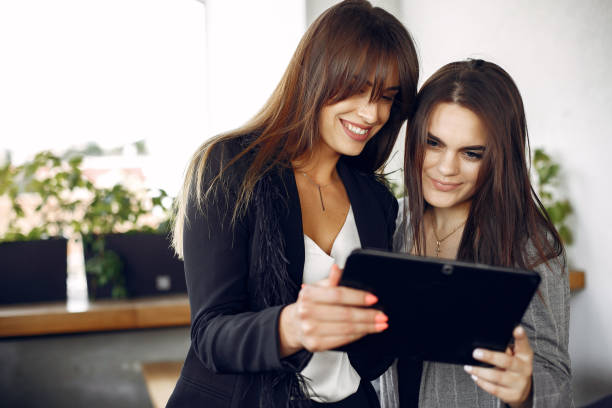 istock Two businesswomen working in a cafe 1227432105