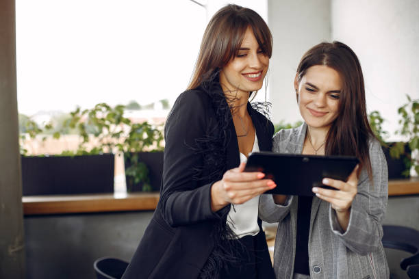 istock Two businesswomen working in a cafe 1227432115
