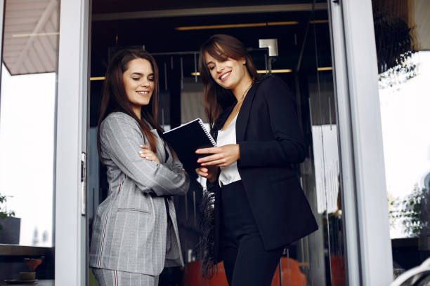 istock Two businesswomen working in a cafe 1227432378