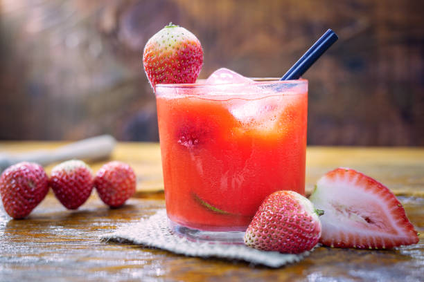 traditional brazilian alcoholic cocktail, strawberry caipirinha with cachaca, sugar syrup, lime, mint, strawberries and crushed ice - caipiroska imagens e fotografias de stock