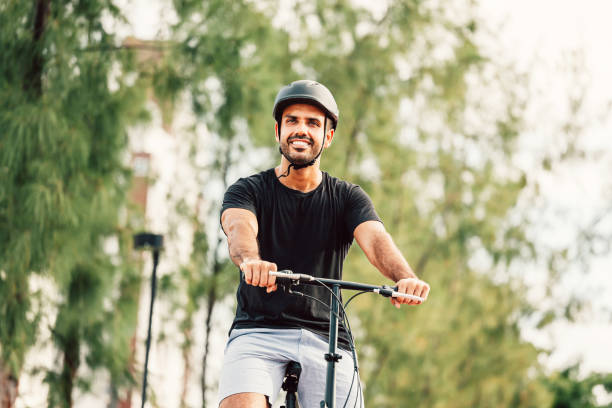 mann fährt allein im park wegen sozialer entfernung fahrrad - bike park stock-fotos und bilder