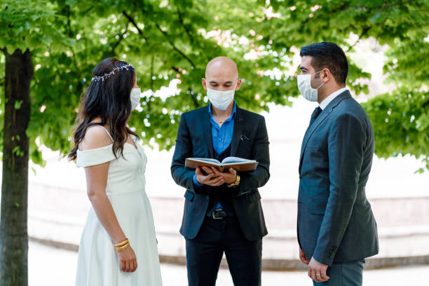 bride and groom in a face protection mask