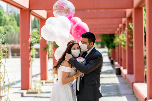 istock bride and groom in a face protection mask 1227435781