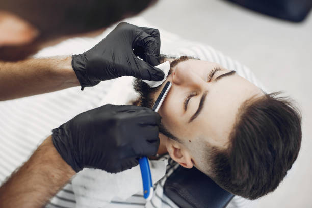 istock Stylish man sitting in a barbershop 1227437936