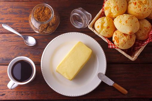 homemade cheese bread, traditional Brazilian snack, on the breakfast table in a rustic farm kitchen. Top view