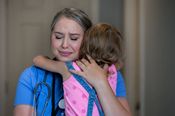 istock Mother looks worried while embracing daughter before work 1227439301
