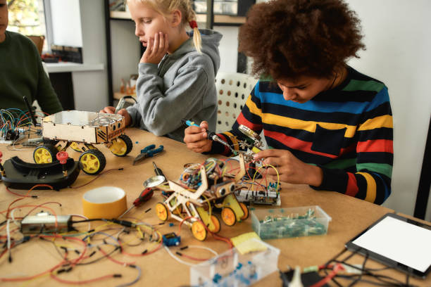 istock The impossible just takes a bit longer. Young engineer using soldering iron to join chips and wires. Robotics and software engineering for elementary students. Inventions and creativity for kids 1227441334