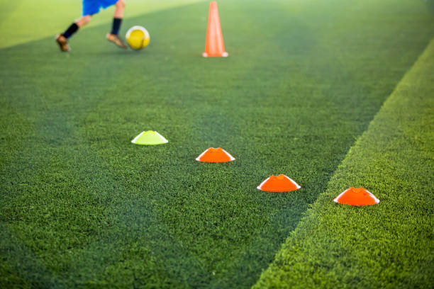 istock selective focus to marker cones are soccer training equipment on green artificial turf 1227442197