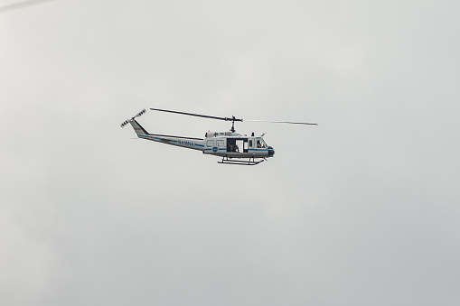 Hoovering helicopter. Blue sky.