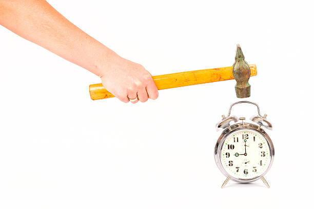 clock and hand Alarm clock and hand with hammer smash alarm clock stock pictures, royalty-free photos & images