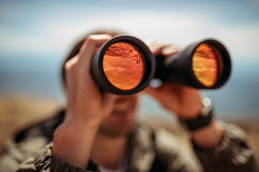 Man looking through binoculars