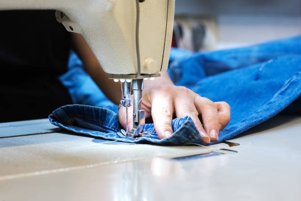 istock Hands of a seamstress work. With her sewing machine sew clothes 1227449327
