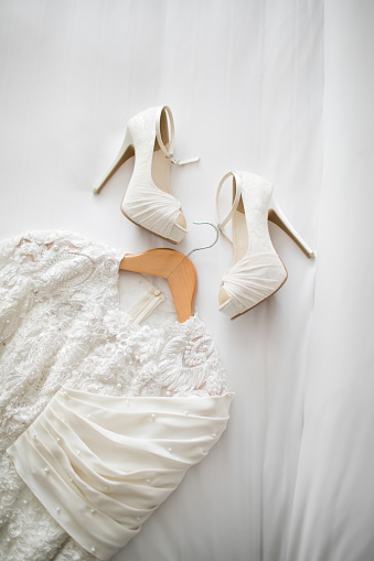 flat lay shoot of a wedding dress and heels