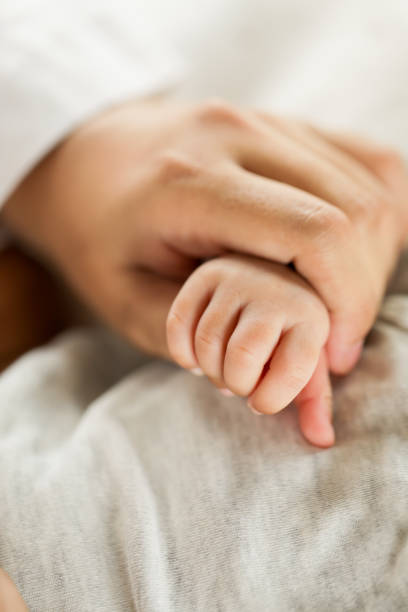 istock a mother holding her new born son 1227449614