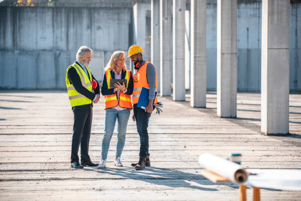 istock Mature Project Managers Meeting with Foreman Onsite 1227451820
