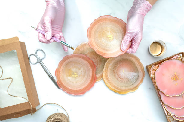 istock Creativity and craft. A young girl creates coasters from resin. Gift wrapping. Decorative packaging. Idea for business. Remote work, work at home. Art coasters. 1227451838