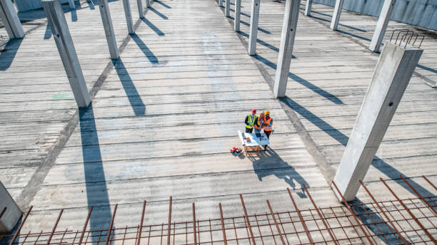 istock Construction Team Meeting Onsite Amidst Steel and Shadows 1227451841