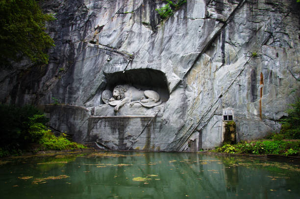 Luzern, Switzerland, September 15, 2016: Lion Monument (Lewendenkmal), a historic landmark, was carved in the rock to honor the Swiss Guards of Lois XVI of France