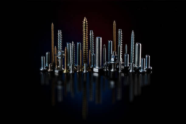 istock Screws and bolts on a black background. Small self-tapping screws and mounting screws. Consumable material for construction. 1227452032