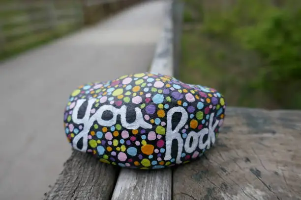 Kindness rock with painted you rock message and colorful polka dots