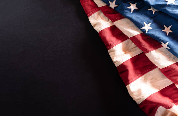 istock Happy Independence Day. American flags against a black  background. July 4. 1227454812