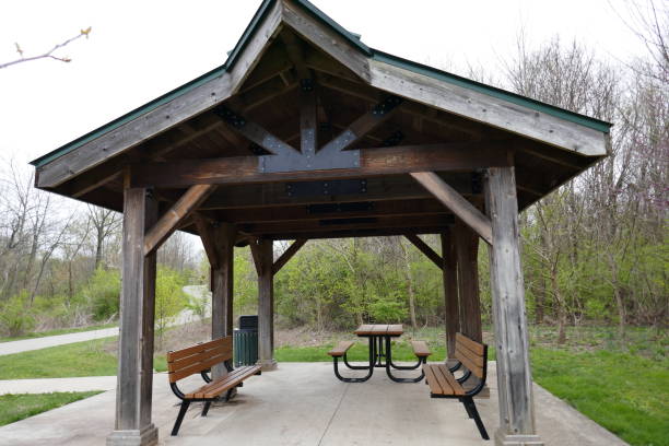 istock Covered shelter rest stop in public park with benches and picnic table 1227454904