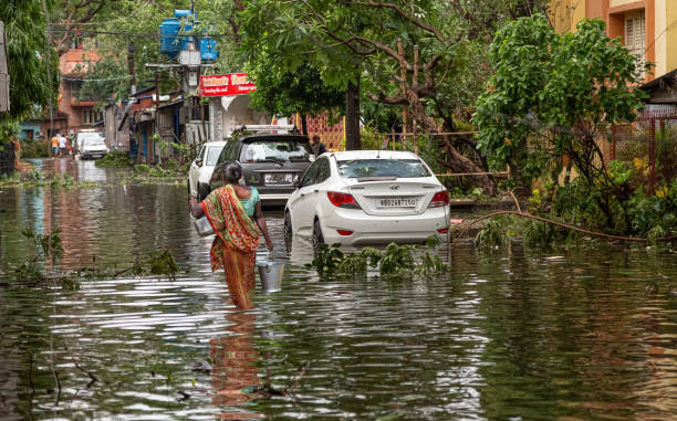 Woman carrying drinking water in flood hit area of Kolkata India stock photo