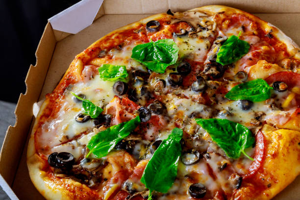 istock Delicious fresh with tasty pizza on black olives basil leaves boiled corn 1227456571