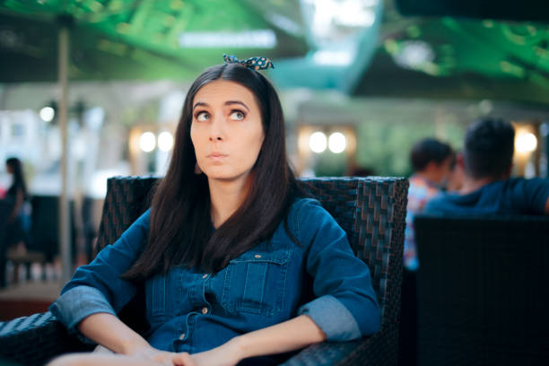 istock Curious Girl Sitting in a Restaurant Spying on Conversation 1227456633