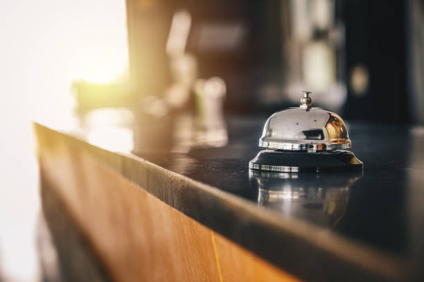 A front desk bell on reception counter. Hotel bell is normally use to call staff service and staff can help guests with any queries that they may have. hostel photos stock pictures, royalty-free photos & images
