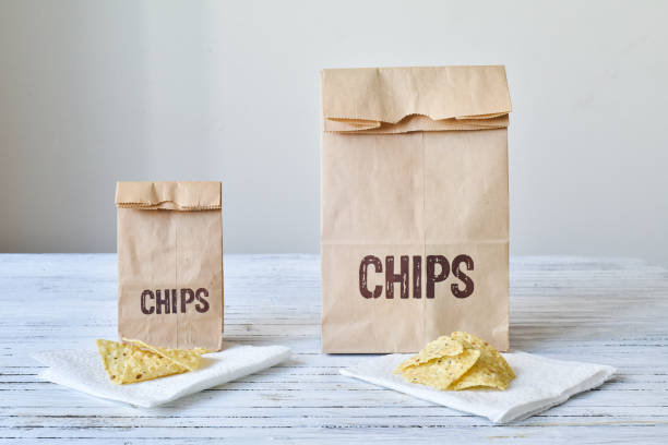 same portion of chips for the large & small bag - portion imagens e fotografias de stock