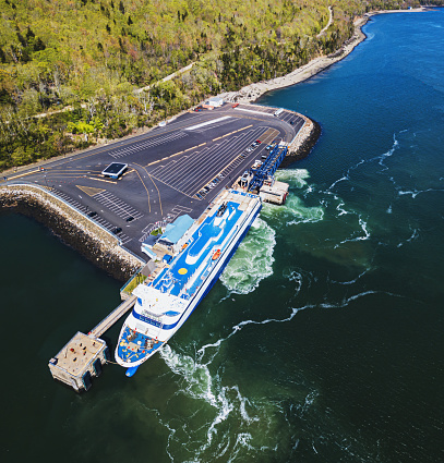 Aerial drone view of passenger ferry docking at port.