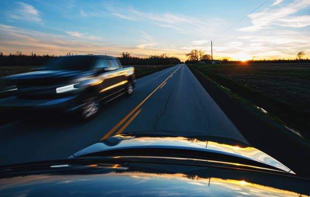 A wide angle view from a roof mounted camera while passing a fellow motorist on a country road.