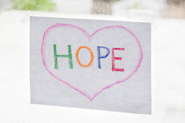 Hope sign and heart taped to a window.
