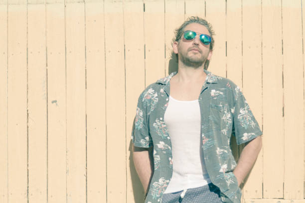 istock Man portrait possing over yellow background at Beach 1227464496