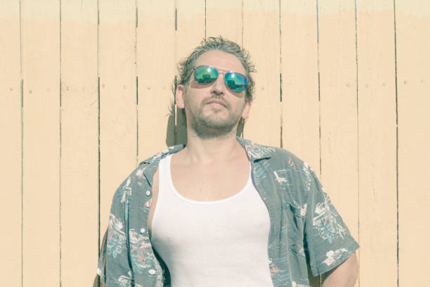 istock Man portrait possing over yellow background at Beach 1227464506