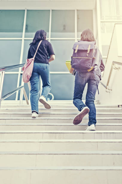 istock college student walking up the staircase 1227464620