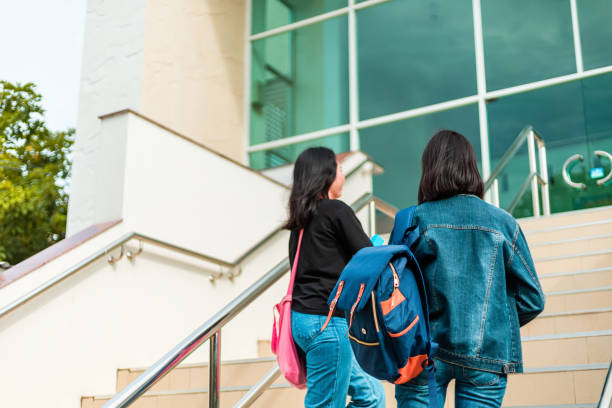 istock college student walking up the staircase 1227465465